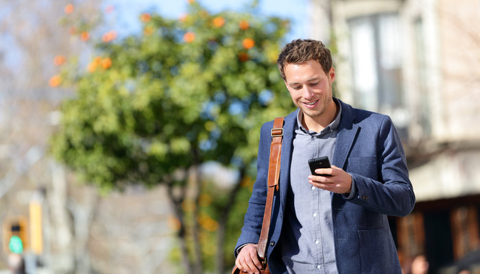 Young urban professional man using smart phone