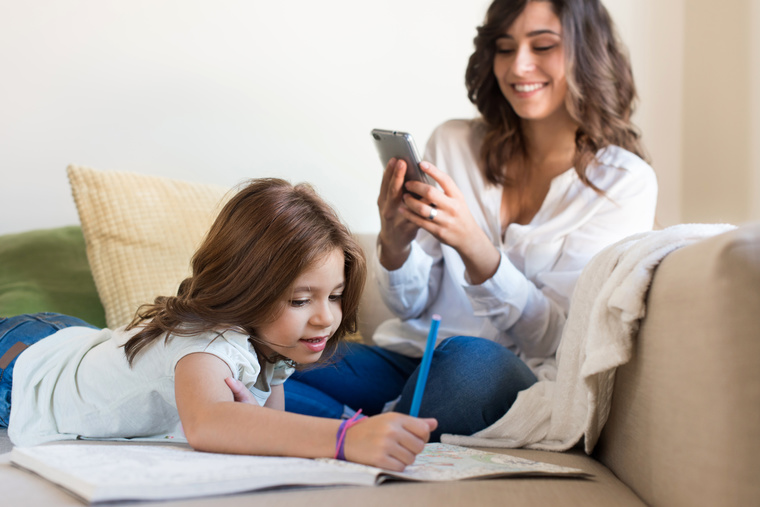 Girl painting with her mom