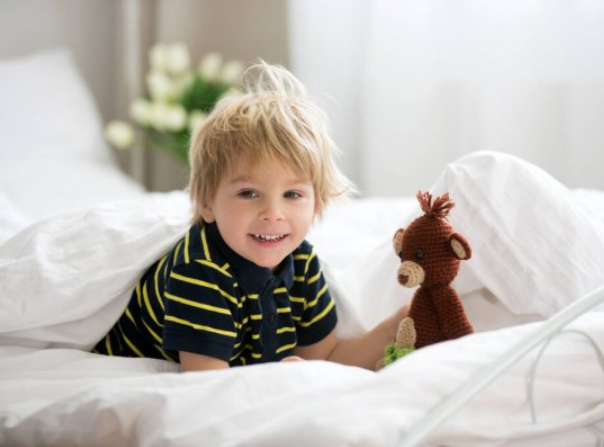 Young boy in a cosy bed - warm in the winter - heat pumps by Heat and Cool Auckland